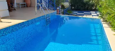 a large blue swimming pool with a blue fence at Villa Agassi Aspo Apokoronas Crete in Koprána