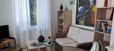 a living room with a chair and a table at Villa Agassi Aspo Apokoronas Crete in Koprána