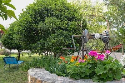 a garden with a statue in a flower garden at Chania Garden Retreat in Souda