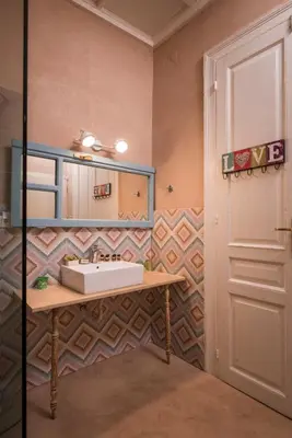 a bathroom with a sink and a mirror at TheJoy in Chania Town