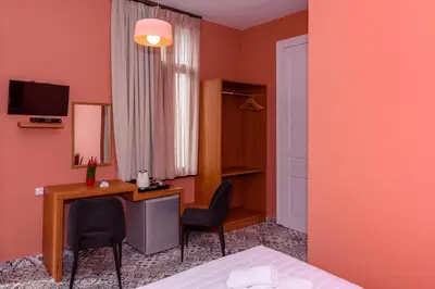 a room with a desk and two chairs and a bed at TheJoy in Chania Town