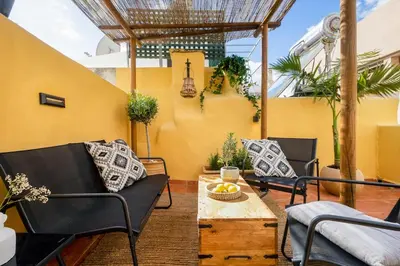 a patio with two chairs and a table at Maisonette in center of Chania with roofgarden! in Chania Town