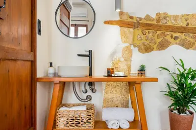 a bathroom with a wooden shelf and a mirror at Maisonette in center of Chania with roofgarden! in Chania Town