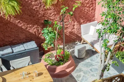 a patio with a table and chairs and plants at Central old Town house with jacuzzi and yard,4ppl in Chania Town