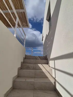 a staircase leading up to a building with the sky in the background at Aldea Apartments in Palio Gerani