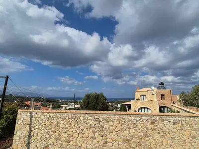 a stone wall in front of a building at Aldea Apartments in Palio Gerani