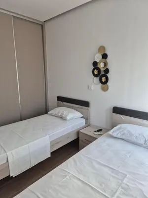 two beds in a room with two beds sidx sidx sidx at Aldea Apartments in Palio Gerani