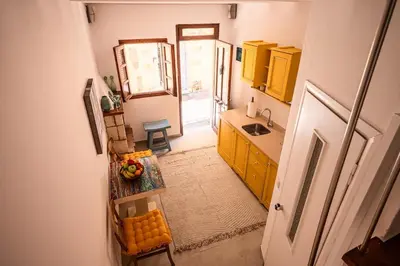an overhead view of a kitchen with yellow cabinets at Romantic Maisonette in Chania Town