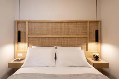 a bedroom with a large bed with white pillows at Paradise for Couples, Next to Soothing Waves in Galatás