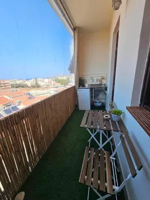 a balcony with two benches and a large window at Cozy Room wtih Amazing Sea View of the Old Harbour in Chania Town