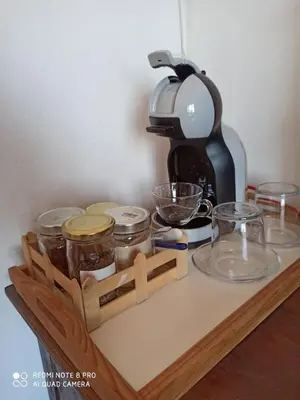 a wooden shelf with jars and a coffee maker on it at Cozy Room wtih Amazing Sea View of the Old Harbour in Chania Town