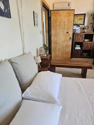 a bedroom with a bed and a table and a door at Cozy Room wtih Amazing Sea View of the Old Harbour in Chania Town