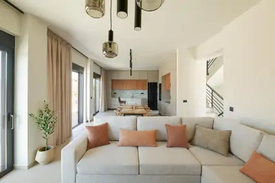 a living room with a couch and a table at Madre Tierra Boutique Villa 1 in Liyidhés