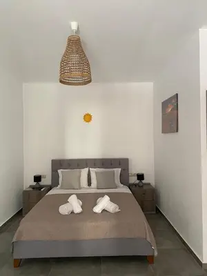 a bedroom with a bed with two towels on it at Tile Apartments 2 in Agia Marina Nea Kydonias