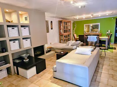 a living room with a couch and a table at Zen House with Fairytale Garden & Sea View in Daratso