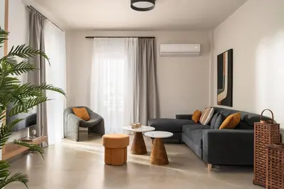 a living room with a couch and a table at Nea Chora Boutique Apartment in Chania Town