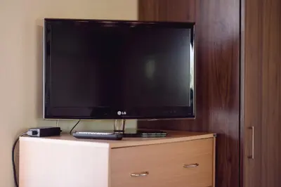 a flat screen tv sitting on top of a dresser at Nicola's House in Tsivarás