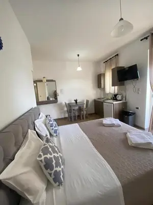 a bedroom with a large bed with pillows on it at Tile Apartments 5 in Agia Marina Nea Kydonias
