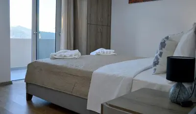 a bedroom with a bed with two towels on it at Tile Apartments 5 in Agia Marina Nea Kydonias