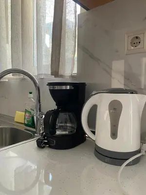 a coffee maker sitting on a counter next to a sink at Tile Apartments 5 in Agia Marina Nea Kydonias