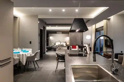 a kitchen with a sink and a dining room at Calmar Boutique Villa 5min drive to Kolymvari beach with Private Pool & Sea Views in Kolymvari