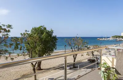 a view of the beach from a balcony at Neachora Beachfront Suites in Chania Town