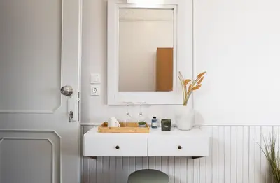 a bathroom with a white sink and a mirror at Neachora Beachfront Suites in Chania Town