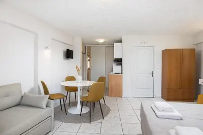 a living room with a couch and a table at Neachora Beachfront Suites in Chania Town