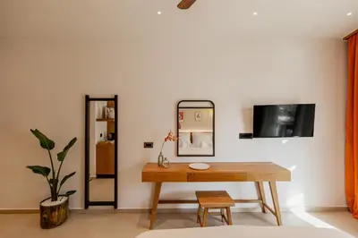 a room with a table and a mirror at Sarana Suites Crete in Kissamos