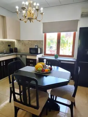 a kitchen with a table with a bowl of fruit on it at La Casa di Teta by superhosthub in Galatás