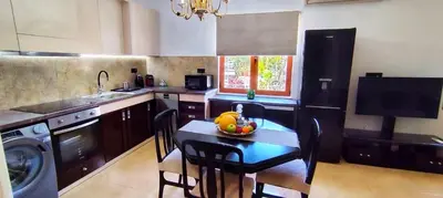 a kitchen with a table with a bowl of fruit on it at La Casa di Teta by superhosthub in Galatás