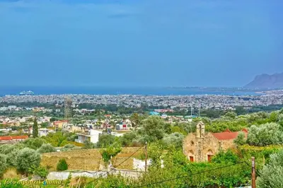 an old building on a hill with a city in the background at Angela Home, 5Street, Perivolia in Perivólia