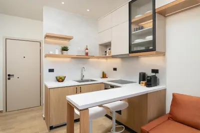 a kitchen with a white counter top and a sink at Kydoni Signature Apartment in Chania Town