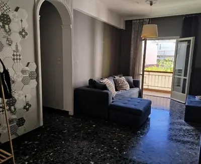 a living room with a blue couch and a window at Serenity Apartment Chania City Centre in Chania Town