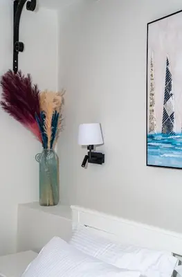 a bedroom with a vase with feathers in it at Amy's Little Gem in Chania Town