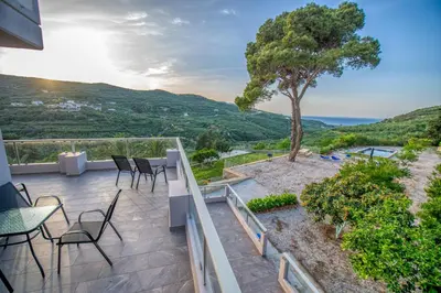 a balcony with tables and chairs and a view at Earthly Paradise in Kissamos