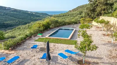 an image of a pool and chairs on a hill at Earthly Paradise in Kissamos