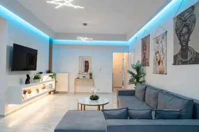a living room with a couch and a table at Nafsika's Cozy Apartment in Chania Town