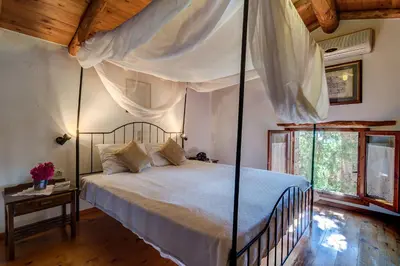 a bedroom with a large bed with a canopy at Natalia's Houses in Chania Town