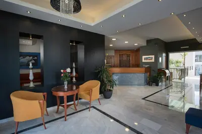 a lobby of a hotel with a table and chairs at Lito Beach Hotel in Gerani Chanion