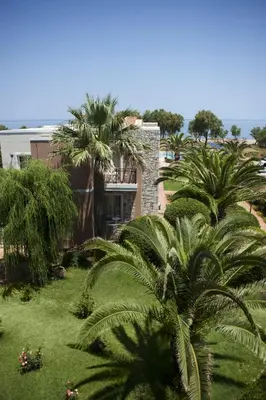a building with palm trees in front of it at Lito Beach Hotel in Gerani Chanion