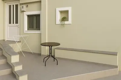 a room with a table and some stairs at Yalos Tiny Studio - 5 mins to Elafonisi beach in Agios Padeleimon