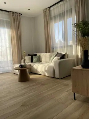 a living room with a white couch and windows at Casa Nero in Chania Town