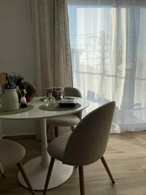 a white table and chairs with a table and a window at Casa Nero in Chania Town