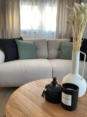 a living room with a couch and a table with a vase at Casa Nero in Chania Town
