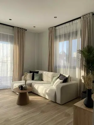 a living room with a white couch and a table at Casa Nero in Chania Town