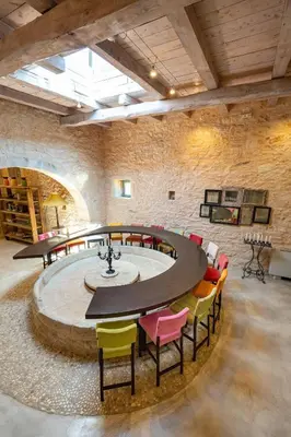 a large room with a round table and chairs at Villa Athermigo in Gavalochori