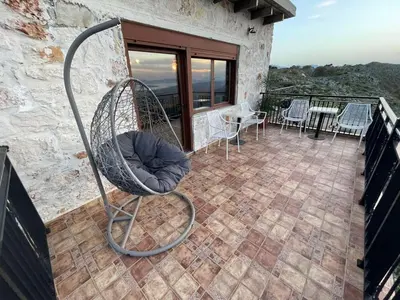 a swing chair on the balcony of a house at Viewphoria in Maláxa