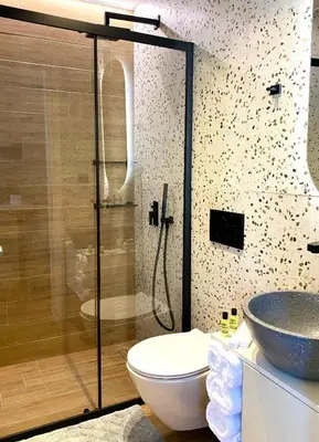 a bathroom with a shower and a toilet and a sink at Eftihia Studios Paleochora in Palaiochóra
