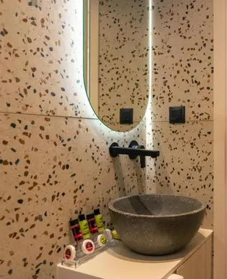 a bathroom with a bowl sink and a mirror at Eftihia Studios Paleochora in Palaiochóra